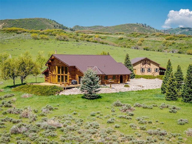 23125 Fawn Creek Rd, Steamboat Springs, CO 80487 - back of property with log siding, a mountain view, a standing seam roof, and a rural view