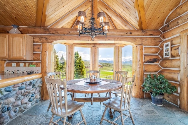 23125 Fawn Creek Rd, Steamboat Springs, CO 80487 - dining space with log walls, wooden ceiling, stone finish floors, and a chandelier