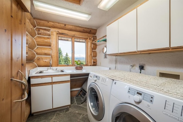 23125 Fawn Creek Rd, Steamboat Springs, CO 80487 - laundry area with cabinet space, rustic walls, and washer and clothes dryer