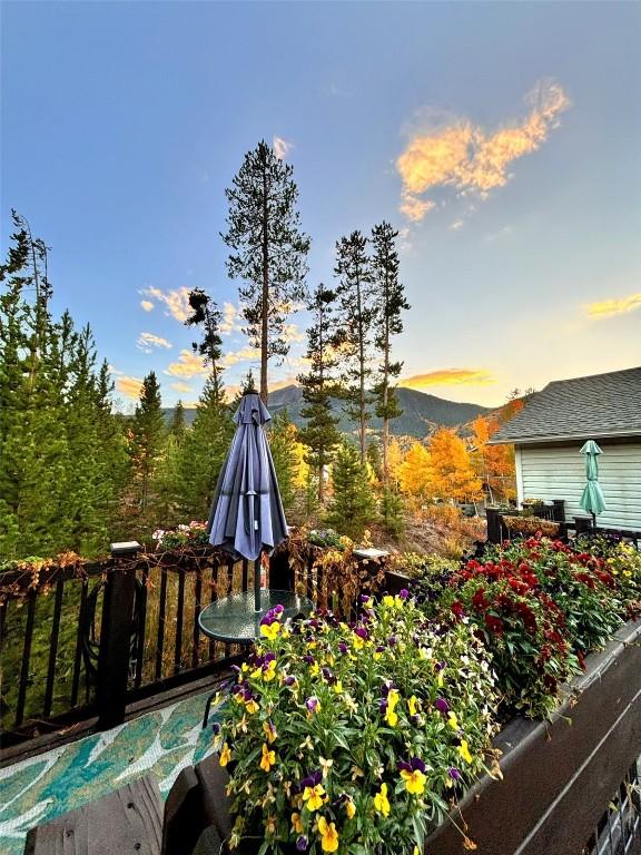113 Peak One Cir Unit 113, Frisco, CO 80443 - deck at dusk featuring a mountain view