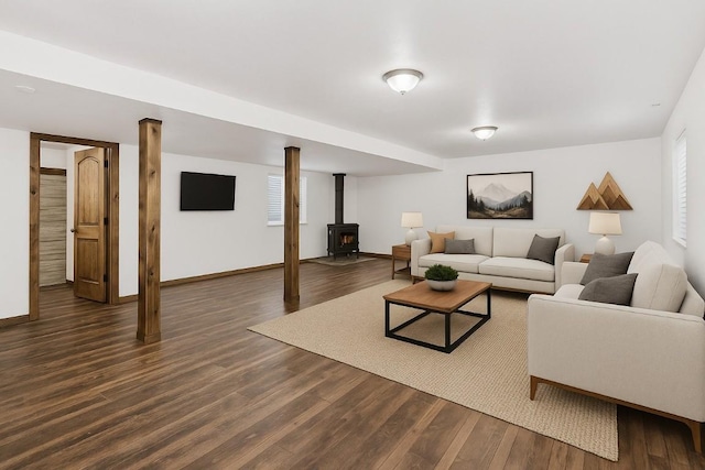 21775 4th Ave, Phippsburg, CO 80469 - living area featuring dark wood finished floors, a wood stove, and baseboards