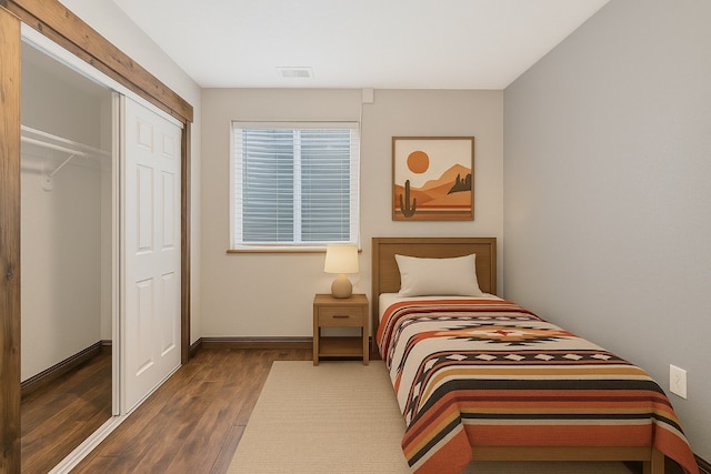 21775 4th Ave, Phippsburg, CO 80469 - bedroom featuring wood finished floors, a closet, and baseboards