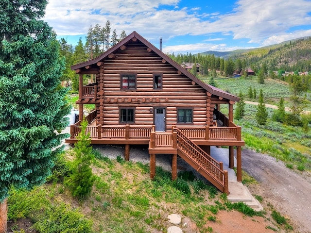 922 Braddock Dr, Breckenridge, CO 80424 - view of front of house featuring log exterior and a deck with mountain view
