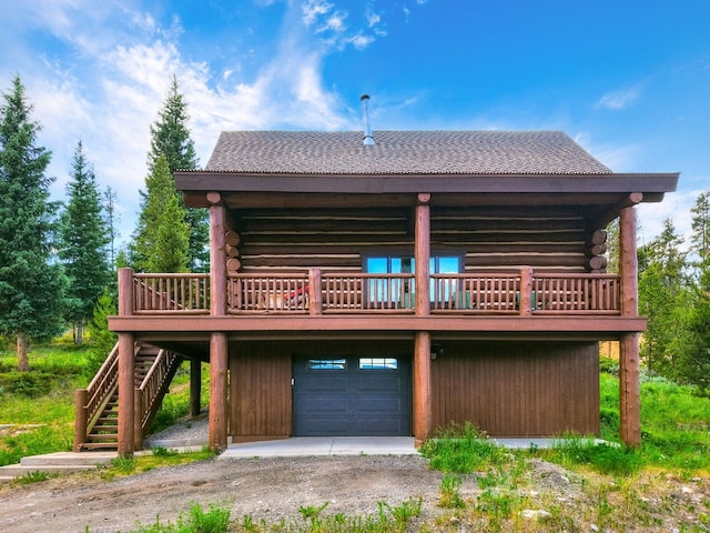 922 Braddock Dr, Breckenridge, CO 80424 - back of property featuring log exterior, stairway, a garage, driveway, and a deck