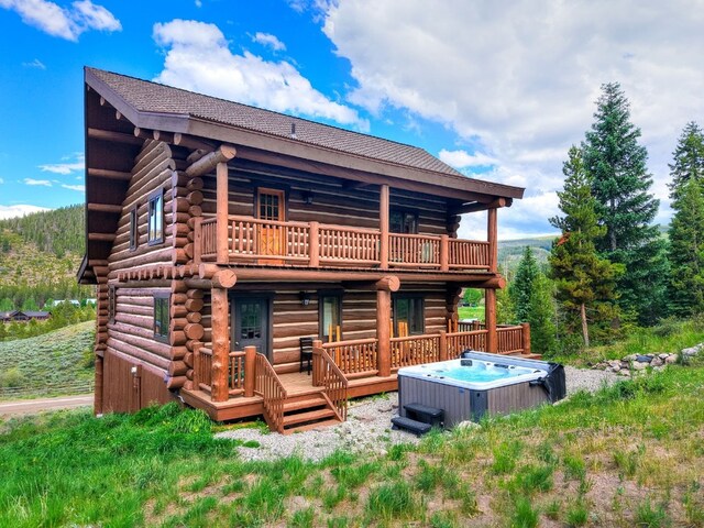 922 Braddock Dr, Breckenridge, CO 80424 - back of property with a hot tub, log siding, and a deck