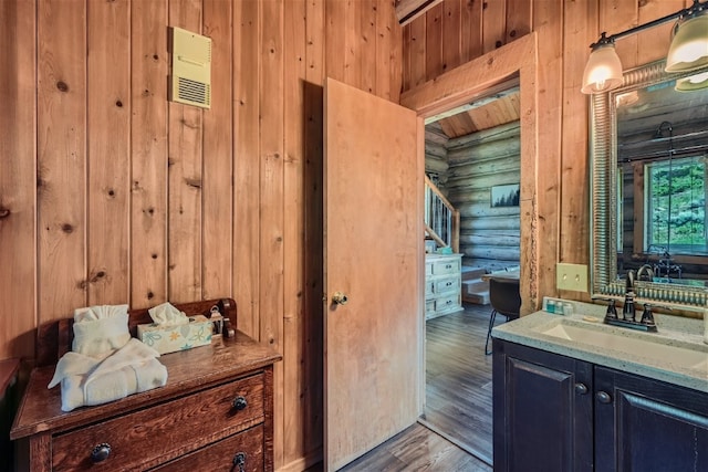 922 Braddock Dr, Breckenridge, CO 80424 - bathroom featuring log walls, vanity, wood finished floors, and wooden walls