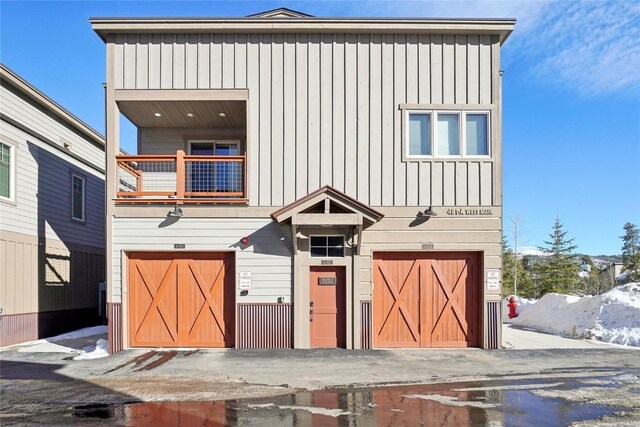 481 W Main St Unit A201, Frisco, CO 80443 - view of front of house with an attached garage, a balcony, and board and batten siding