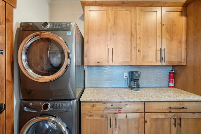 481 W Main St Unit A201, Frisco, CO 80443 - clothes washing area featuring cabinet space and stacked washer and clothes dryer