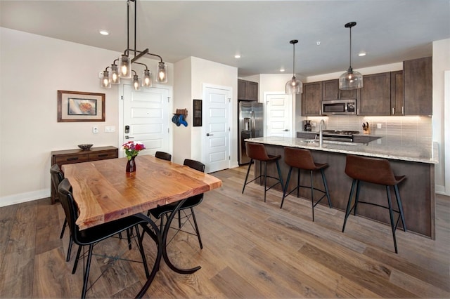 235 E Ln Bonte St Unit 207, Dillon, CO 80435 - dining space featuring wood finished floors, recessed lighting, and a chandelier