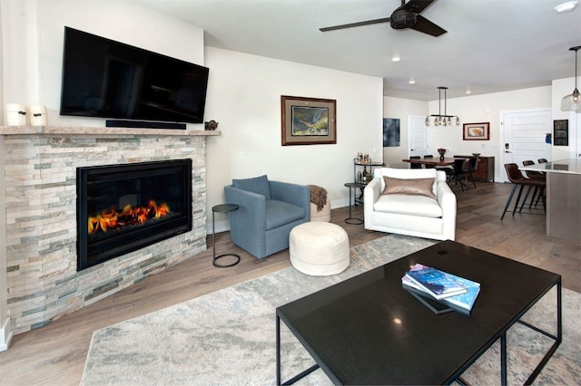 235 E Ln Bonte St Unit 207, Dillon, CO 80435 - living room featuring ceiling fan, wood finished floors, a fireplace, and recessed lighting