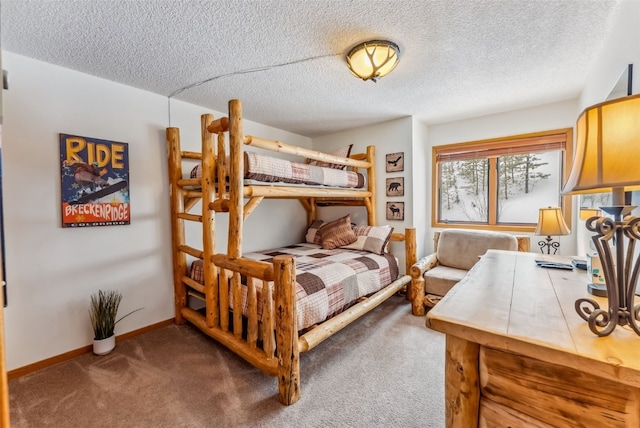 bedroom with baseboards, carpet flooring, and a textured ceiling