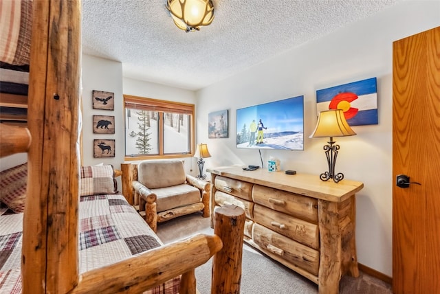 sitting room with carpet flooring and a textured ceiling