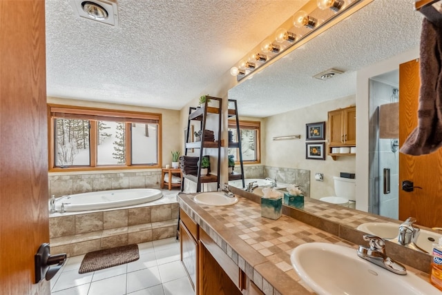 full bath with a healthy amount of sunlight, a sink, and tile patterned floors