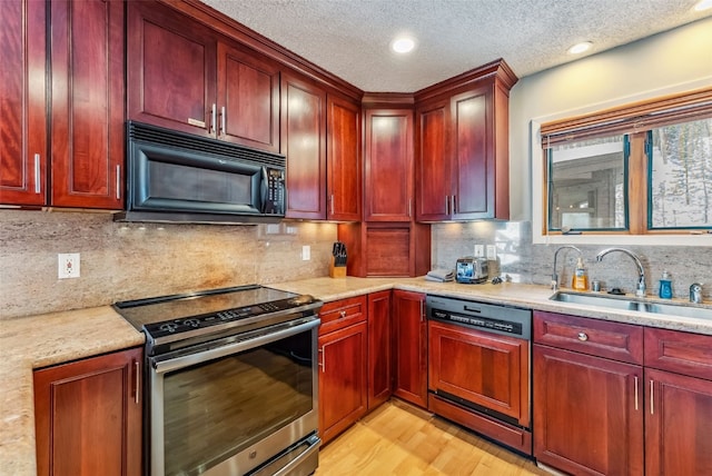 kitchen featuring black microwave, dishwasher, reddish brown cabinets, and stainless steel range with electric stovetop