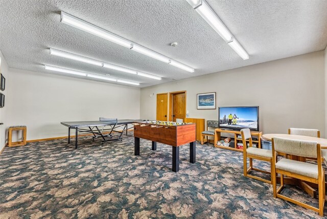 playroom with carpet floors and a textured ceiling