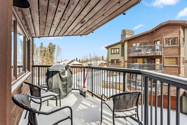 view of snow covered back of property
