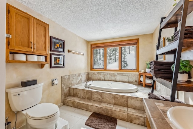 full bathroom with a textured ceiling, toilet, baseboards, tile patterned flooring, and a garden tub