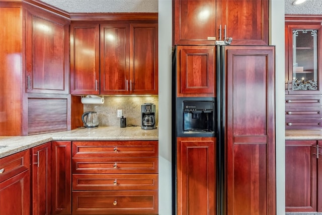 kitchen with dark brown cabinets, a textured ceiling, paneled built in fridge, and decorative backsplash