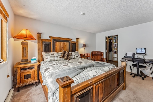 bedroom with a closet, a textured ceiling, and light colored carpet
