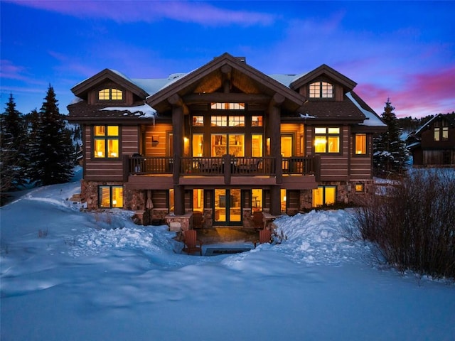 view of snow covered rear of property