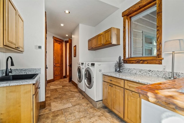 laundry room featuring cabinets, sink, and washer and dryer