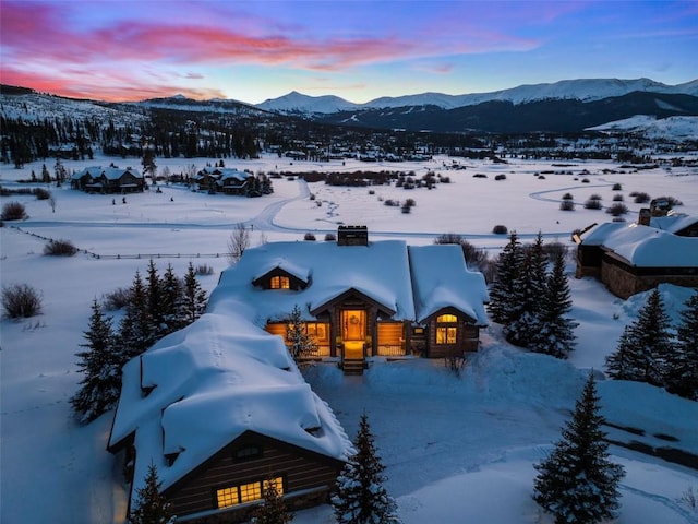 snowy aerial view with a mountain view