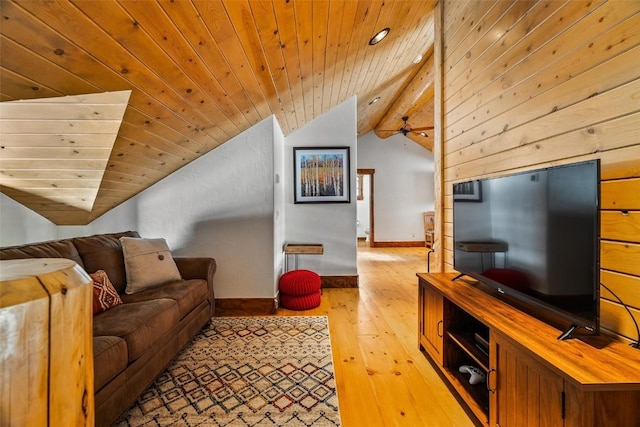 living room with ceiling fan, wood walls, vaulted ceiling with beams, light wood-type flooring, and wood ceiling