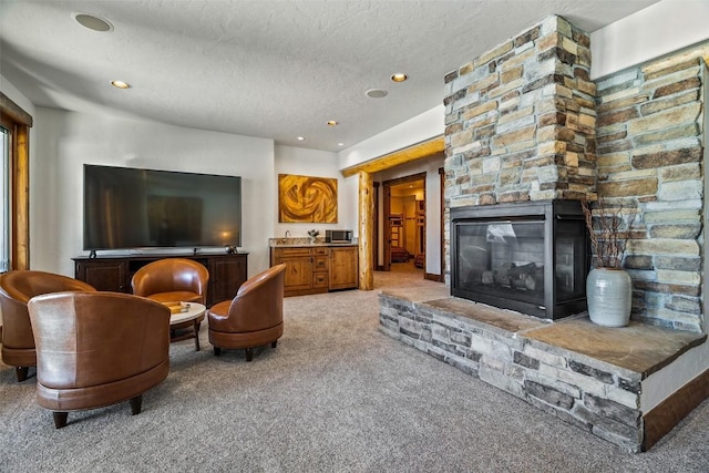 living room with a textured ceiling, light carpet, and a stone fireplace