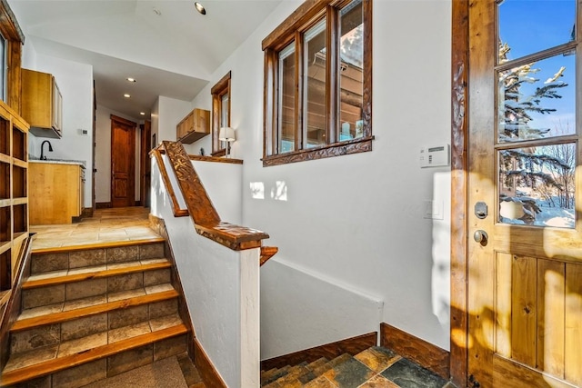 stairway with sink and a healthy amount of sunlight