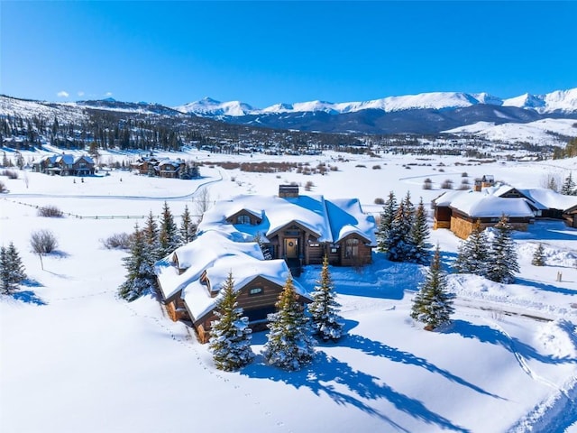 snowy aerial view featuring a mountain view