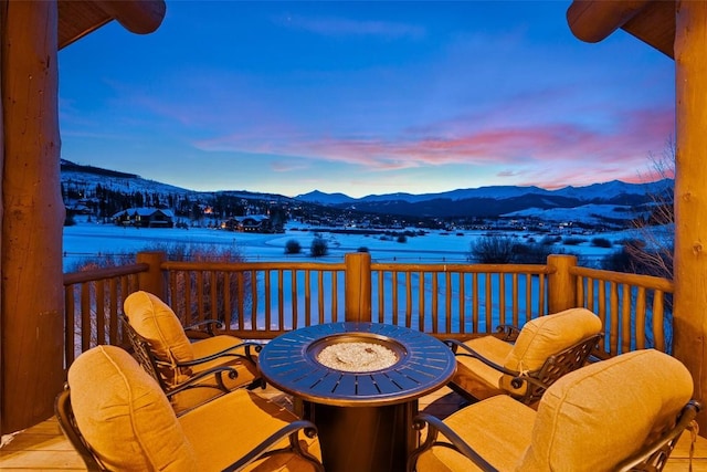 snow covered deck featuring a mountain view