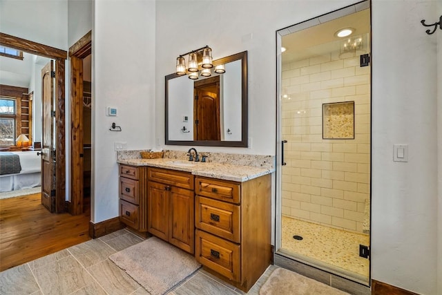 bathroom with vanity and a shower with door