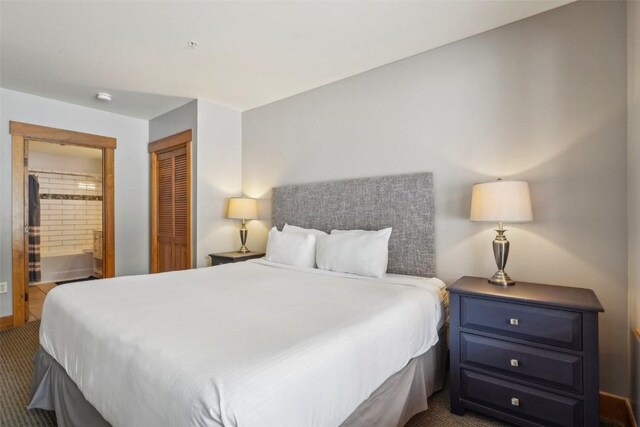 53 Hunki Dori Ct Unit 8806, Keystone, CO 80435 - bedroom featuring dark carpet, connected bathroom, and a closet