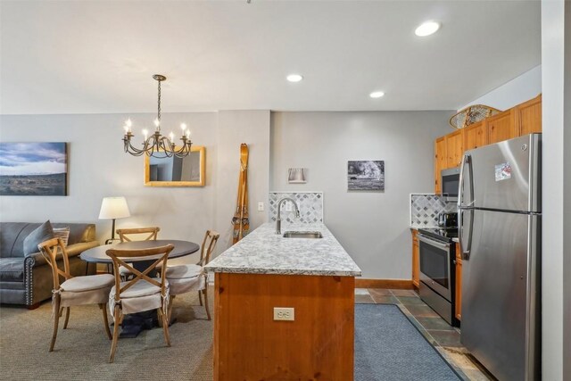 53 Hunki Dori Ct Unit 8806, Keystone, CO 80435 - kitchen featuring a sink, stainless steel appliances, a peninsula, a notable chandelier, and recessed lighting