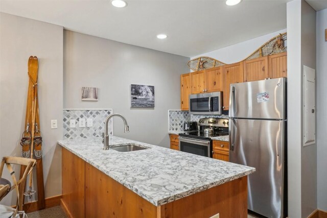 53 Hunki Dori Ct Unit 8806, Keystone, CO 80435 - kitchen with a peninsula, appliances with stainless steel finishes, tasteful backsplash, and a sink