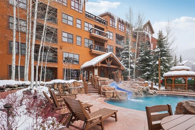 53 Hunki Dori Ct Unit 8806, Keystone, CO 80435 - snow covered pool featuring a water slide, a community pool, and a gazebo