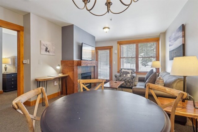 53 Hunki Dori Ct Unit 8806, Keystone, CO 80435 - carpeted dining room with a tiled fireplace, baseboards, and an inviting chandelier