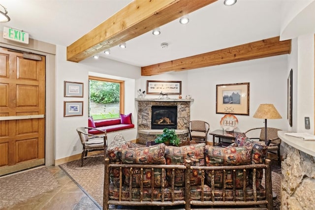 living area featuring beamed ceiling, baseboards, a stone fireplace, and recessed lighting