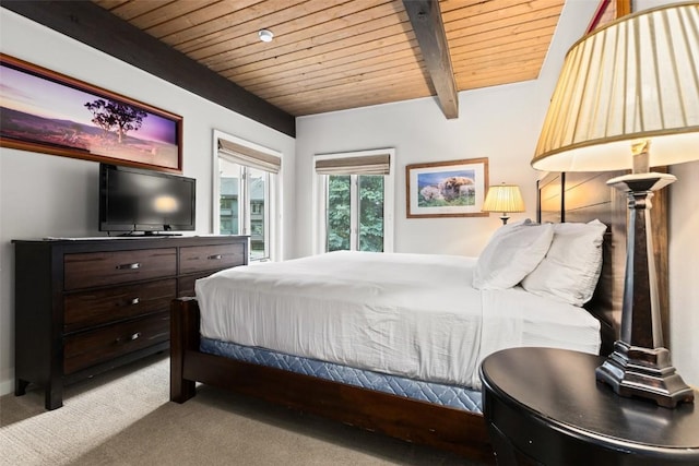 carpeted bedroom with beamed ceiling, wooden ceiling, and access to exterior