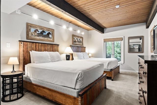 carpeted bedroom featuring wooden ceiling, baseboards, and beam ceiling