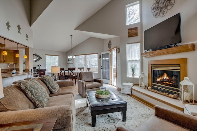 116 Blue Grouse Ln, Silverthorne, CO 80498 - living room featuring high vaulted ceiling, a glass covered fireplace, and a chandelier