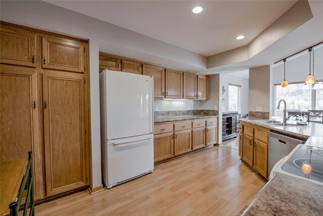 116 Blue Grouse Ln, Silverthorne, CO 80498 - kitchen featuring freestanding refrigerator, a sink, light wood-style flooring, dishwasher, and brown cabinets