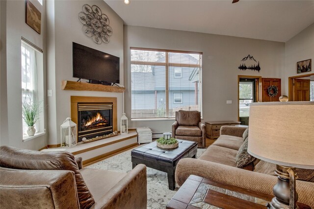 116 Blue Grouse Ln, Silverthorne, CO 80498 - living room featuring a glass covered fireplace, plenty of natural light, and a baseboard heating unit