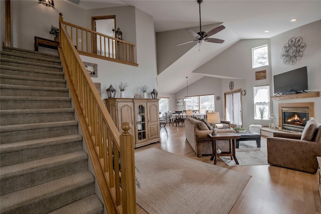 116 Blue Grouse Ln, Silverthorne, CO 80498 - living room featuring high vaulted ceiling, plenty of natural light, light wood finished floors, ceiling fan, and stairway
