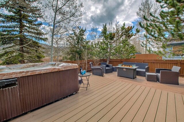 116 Blue Grouse Ln, Silverthorne, CO 80498 - wooden deck with a hot tub and an outdoor living space with a fire pit