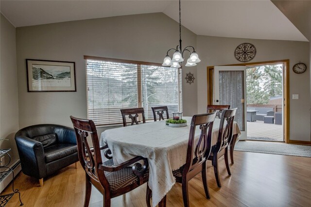 116 Blue Grouse Ln, Silverthorne, CO 80498 - dining area featuring a baseboard radiator, a chandelier, lofted ceiling, and light wood-style floors