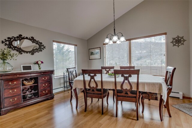 116 Blue Grouse Ln, Silverthorne, CO 80498 - dining room with a baseboard radiator, light wood finished floors, a chandelier, and high vaulted ceiling