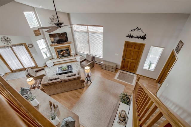 116 Blue Grouse Ln, Silverthorne, CO 80498 - living room with high vaulted ceiling, ceiling fan, healthy amount of natural light, a glass covered fireplace, and wood finished floors