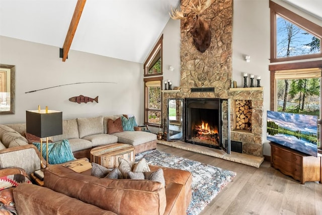 44 Maverick Way, Silverthorne, CO 80498 - living area with a stone fireplace, high vaulted ceiling, beamed ceiling, and wood finished floors