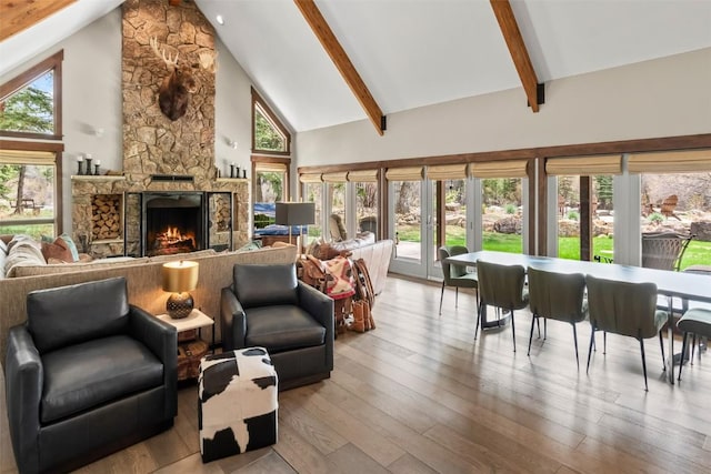 44 Maverick Way, Silverthorne, CO 80498 - living area with high vaulted ceiling, beam ceiling, wood finished floors, and a fireplace
